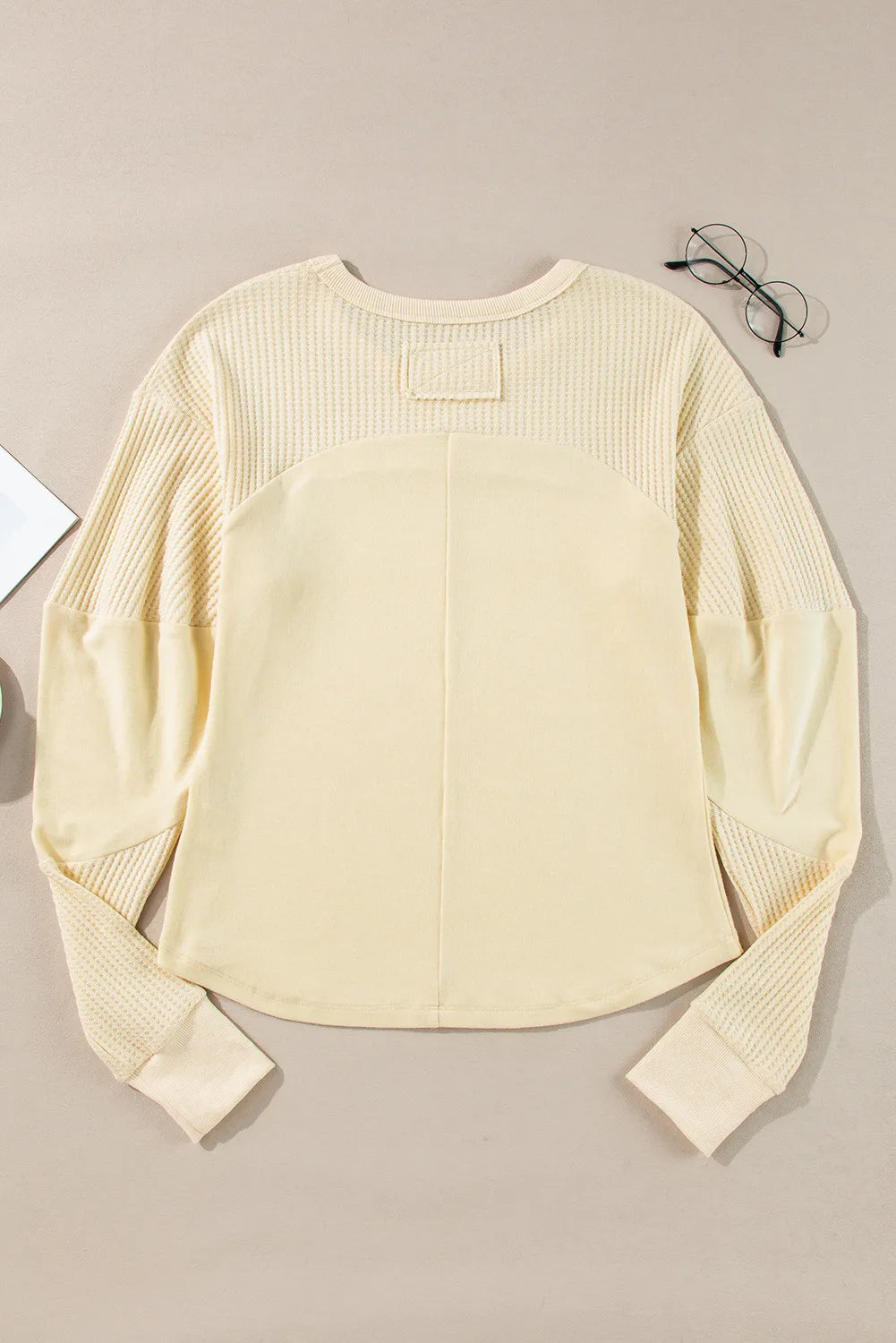 Beige waffle knit colorblock sweatshirt with crewneck and long sleeves.