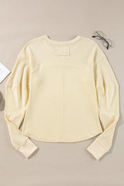 Beige waffle knit colorblock sweatshirt with crewneck and long sleeves.