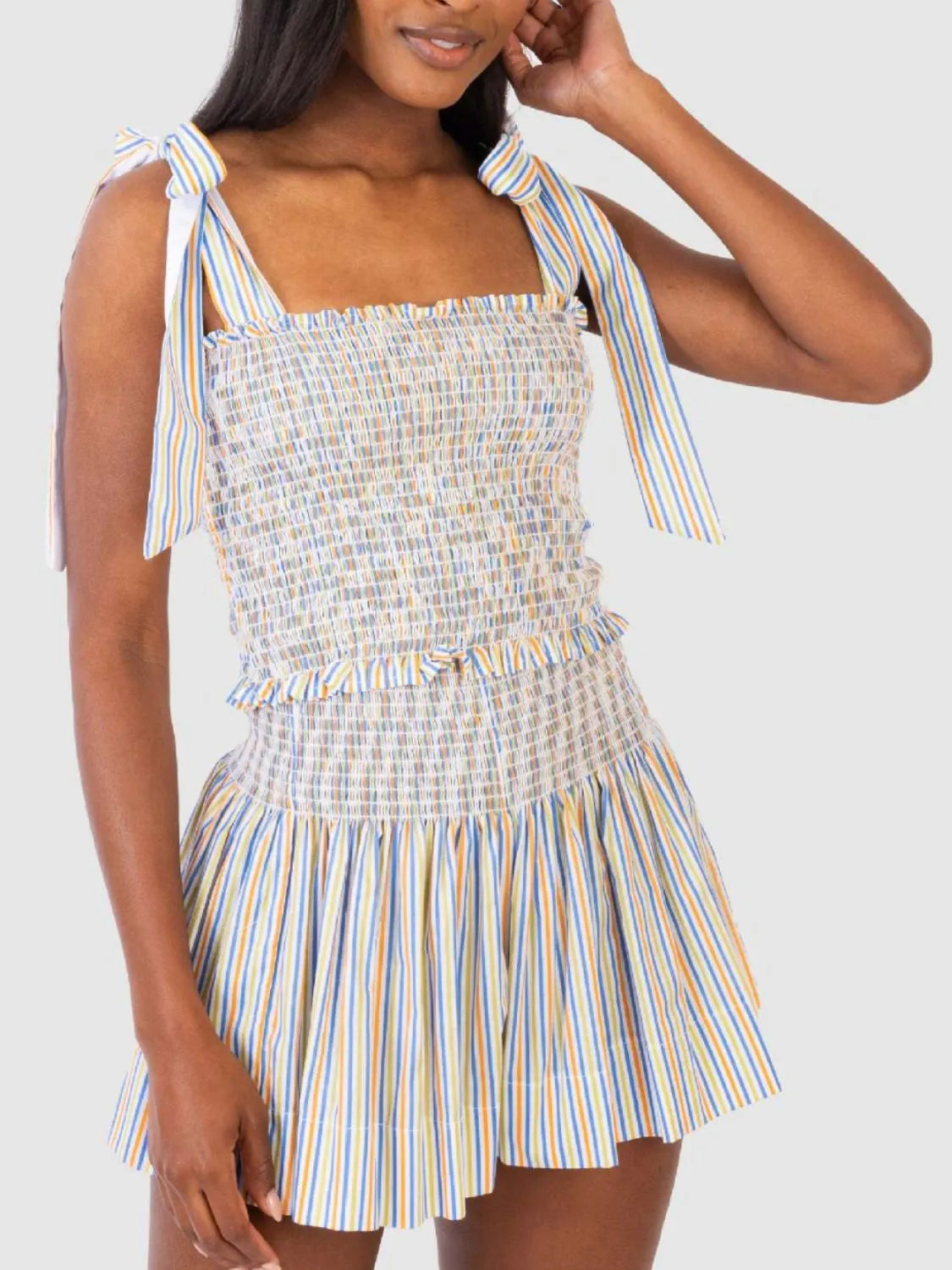 Rainbow striped smocked bodice and shorts set with tie straps and ruffled waist detail.