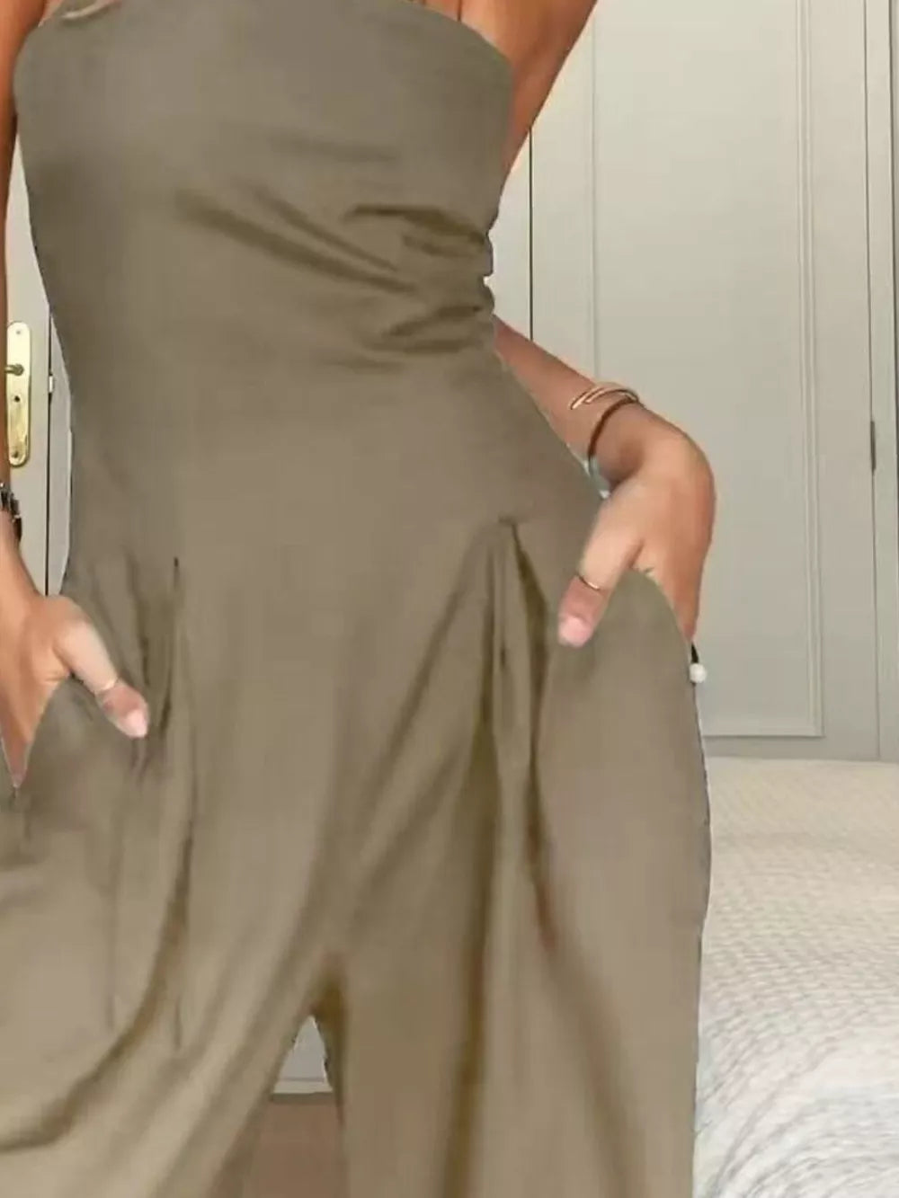Khaki strapless wide-leg maternity romper with pockets and a cinched waist.