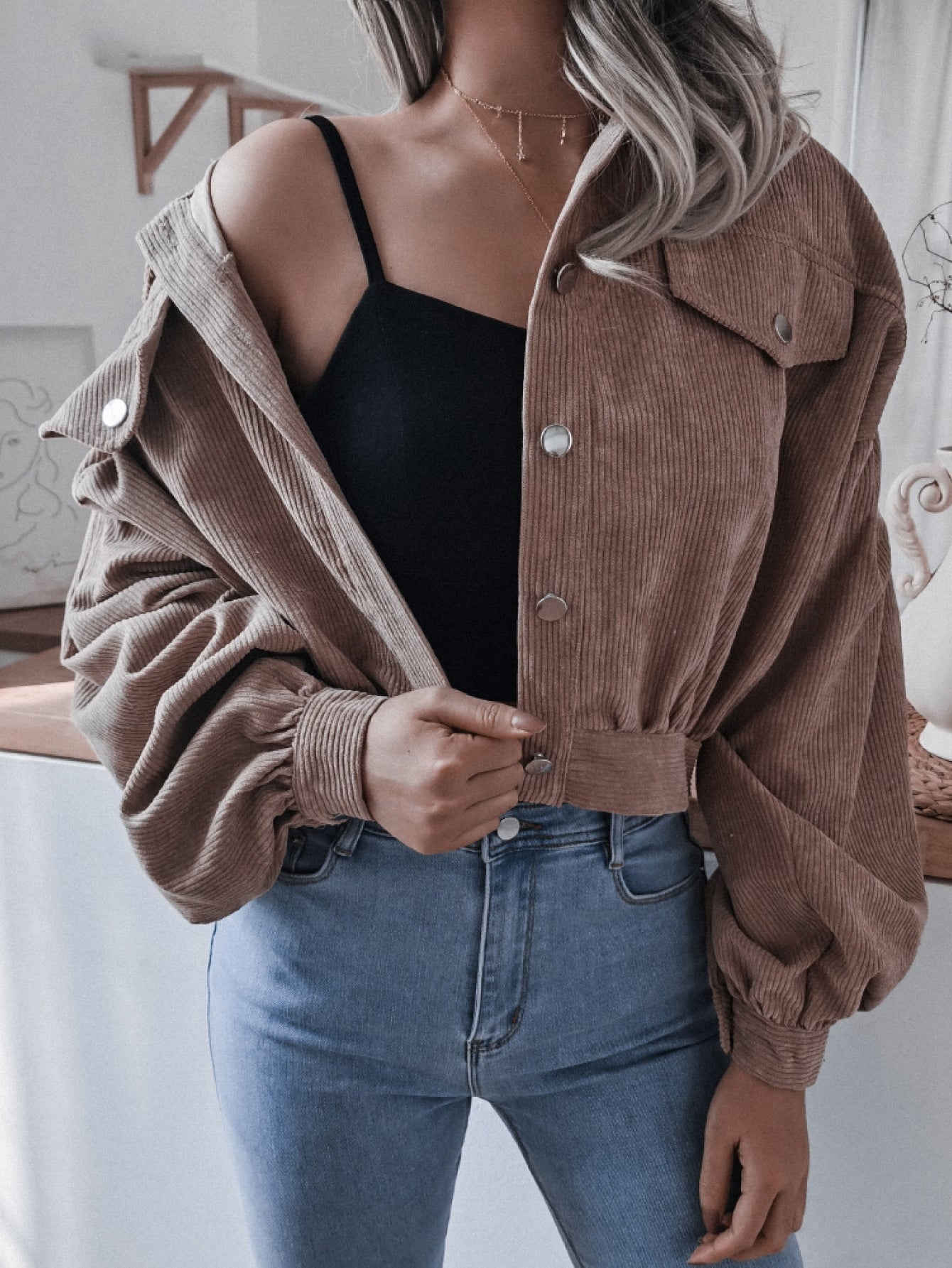 Brown corduroy cropped jacket with balloon sleeves and button-up front.