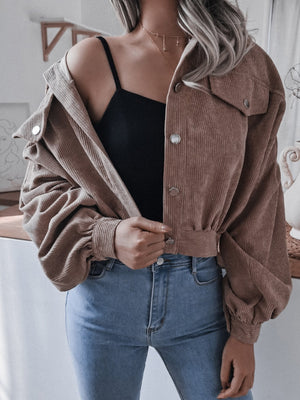 Brown corduroy cropped jacket with balloon sleeves and button-up front.