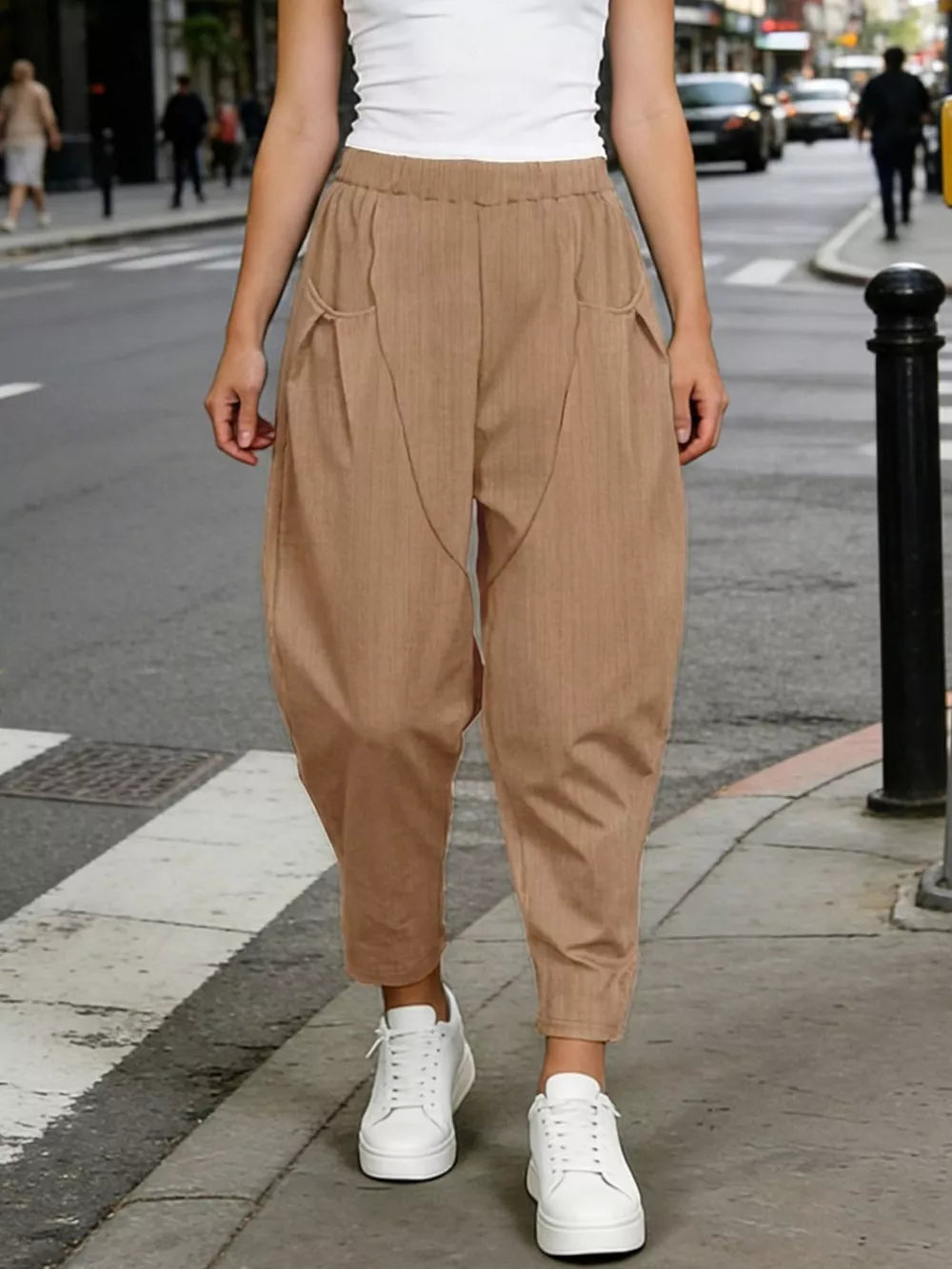 Camel harem joggers with pockets and a pinstripe detail, styled with white sneakers.