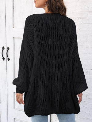 Black knit cardigan with balloon sleeves and pearl buttons, shown from the back.