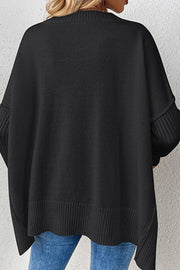 Black V-neck knit sweater with ribbed cuffs and asymmetric hemline.