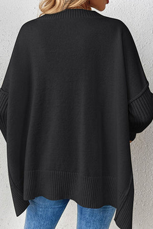 Black V-neck knit sweater with ribbed cuffs and asymmetric hemline.