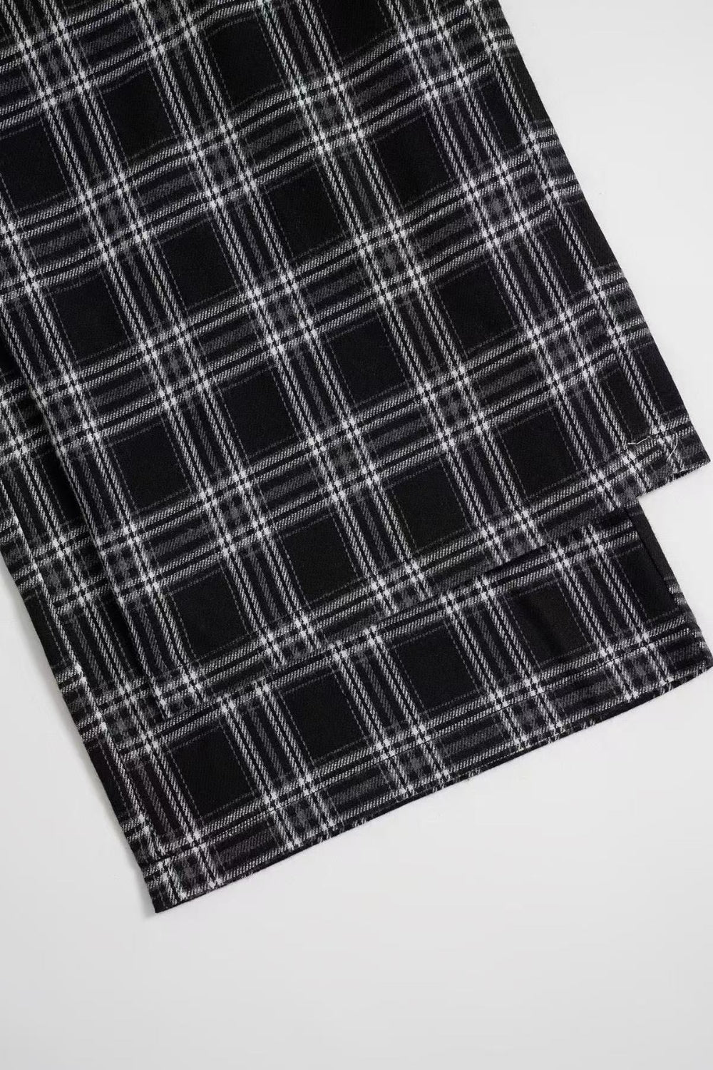 Black plaid palazzo lounge trousers with a comfortable, wide-leg fit.