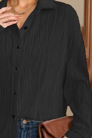 Black pleated wave oversized button-down shirt with a collared neckline and button closure.