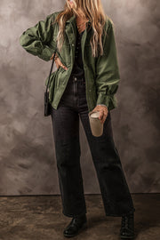 Army green military-inspired jacket with drawstring waist and button front, styled with black jeans.