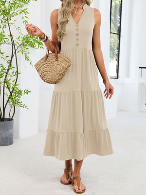 Apricot tiered midi dress with V-neck and decorative buttons, sleeveless.
