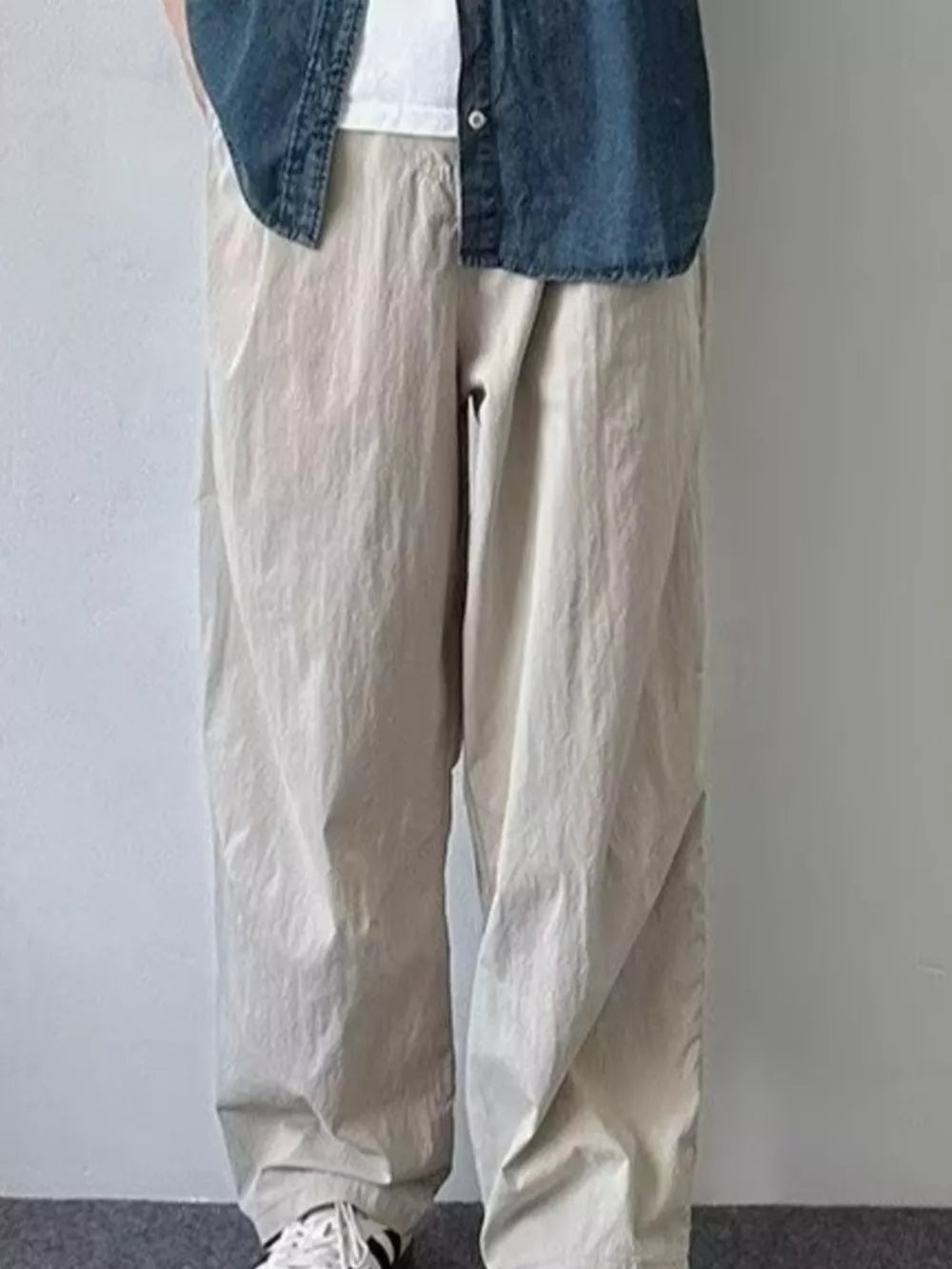 Relaxed fit men's sweatpants in khaki color, featuring a loose cut and casual styling.