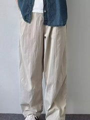 Relaxed fit men's sweatpants in khaki color, featuring a loose cut and casual styling.