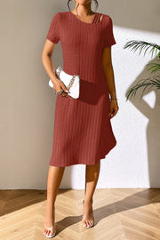 Orange-red ribbed midi dress with short sleeves and a unique shoulder detail.