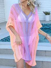 Ombre crochet kaftan cover-up with V-neck and short sleeves in pink, purple, and orange hues.