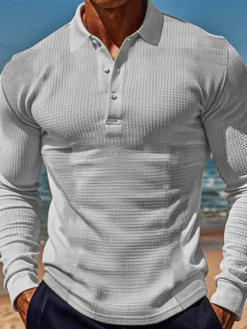Gray textured waffle knit long-sleeve polo shirt with button placket.