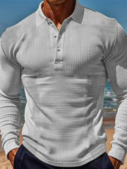 Gray textured waffle knit long-sleeve polo shirt with button placket.