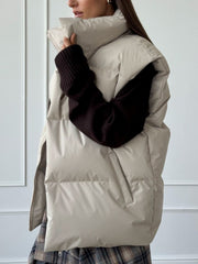 Padded puffer vest in Dust Storm with a high collar and zippered sides.