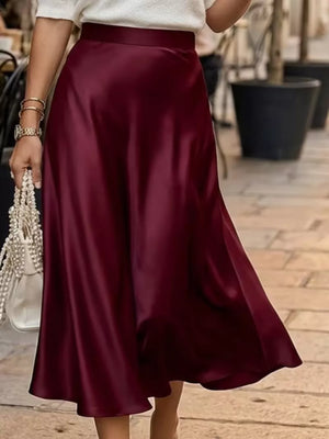 Elegant A-line satin skirt in wine red with a flowing silhouette.