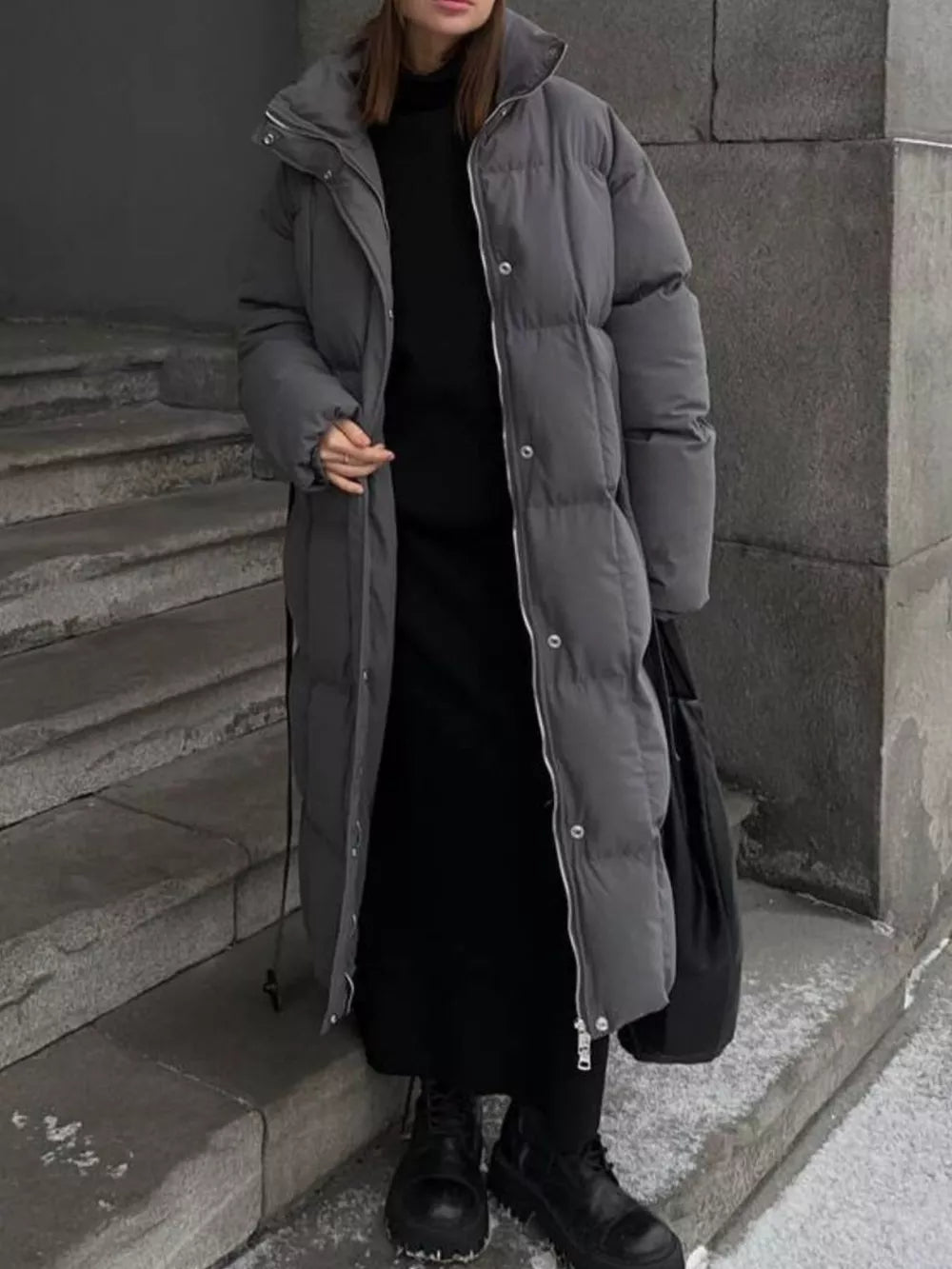 Chic dark gray padded puffer trench coat with tie-belt detail and silver zipper.