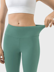 Turquoise high-rise flared sculpt leggings with a wide, flexible waistband.