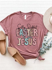 Dusty Pink Easter graphic tee with "Silly Rabbit EASTER is for JESUS" text in pastel polka dots.