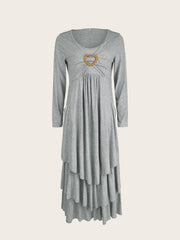 Light gray long sleeve midi dress with tiered hem and heart detail at neckline.
