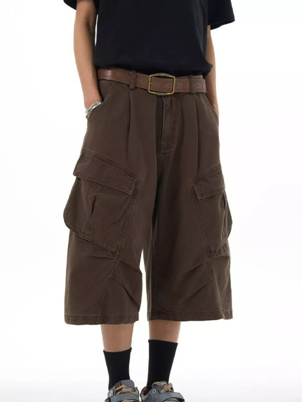 Relaxed chocolate cargo capris with multiple pockets and a brown belt.