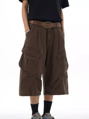 Relaxed chocolate cargo capris with multiple pockets and a brown belt.