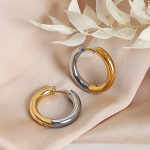 Two-tone segmented hoop earrings in gold and silver with a polished finish.