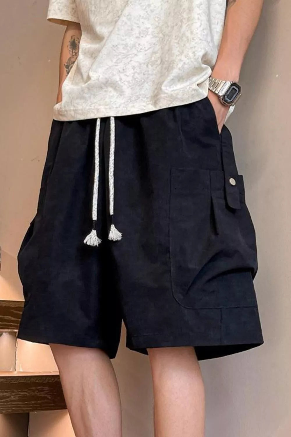 Black relaxed fit drawstring cargo shorts with adjustable waist and multiple pockets.