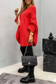 Relaxed knit sweater in Deep Red with cape sleeves and a round neckline.