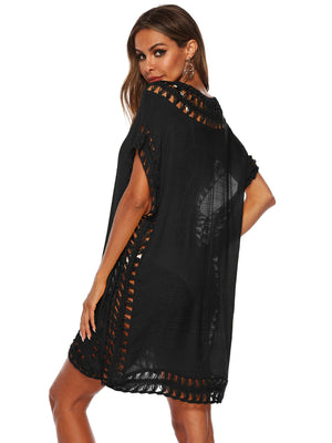 Black kaftan cover-up with crochet trim and fringe details.