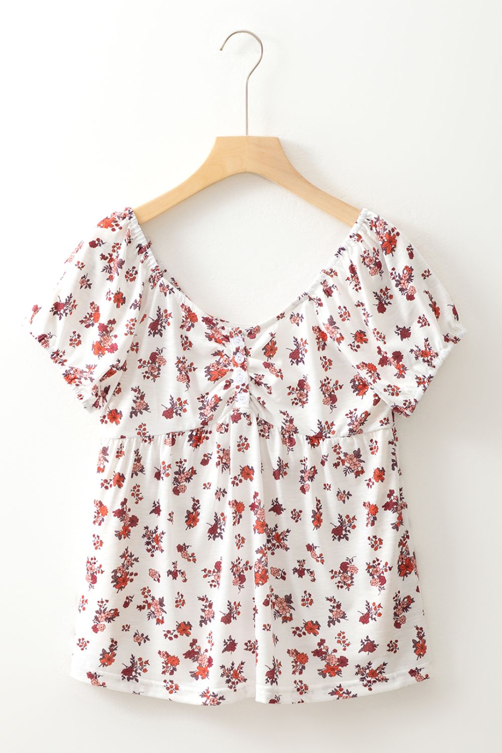 Gathered bust floral puff sleeve blouse with a square neckline and short sleeves.