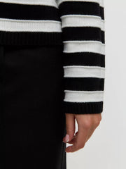 Black and white striped knit cardigan with button-up detail.