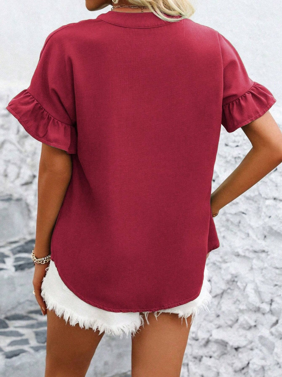 Deep Red blouse with ruffle sleeves and a gathered yoke, styled with white shorts.