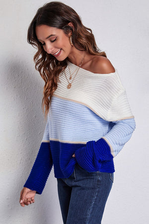 Colorblock ribbed boatneck sweater with blue and white stripes and a wide neckline.