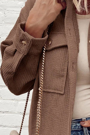 Brown corduroy utility jacket with button cuffs and chest pockets.