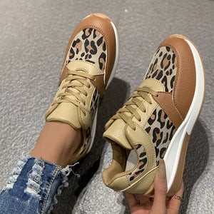 Leopard print lace-up sneakers with brown and tan color-blocking and a white sole.