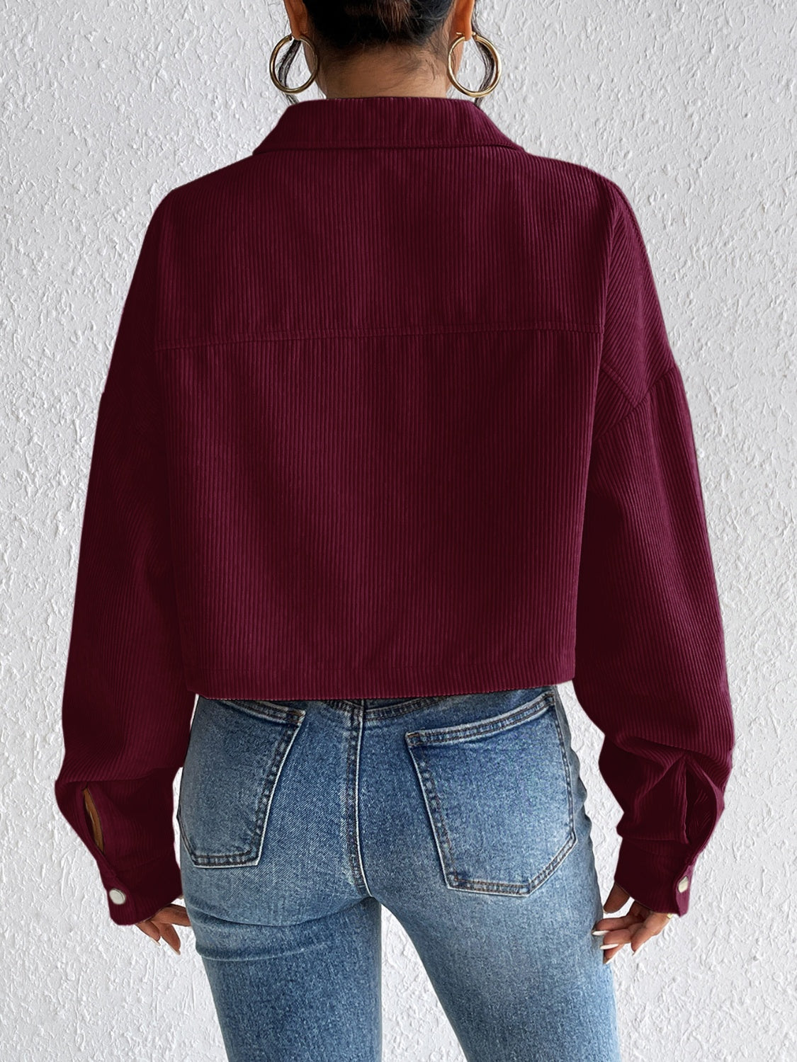 Burgundy corduroy cropped jacket with snap cuffs and collar, shown from the back.
