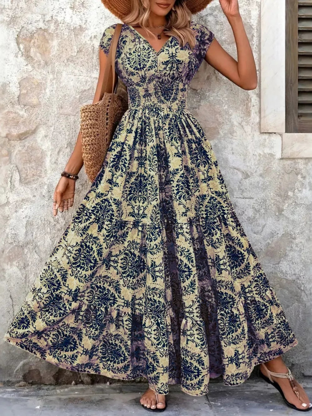Maxi dress with smocked bodice, V-neck, short sleeves, and tiered skirt in a dark blue damask print.