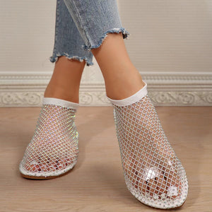 White mesh ankle boots with rhinestones and round toe, styled with ripped jeans.