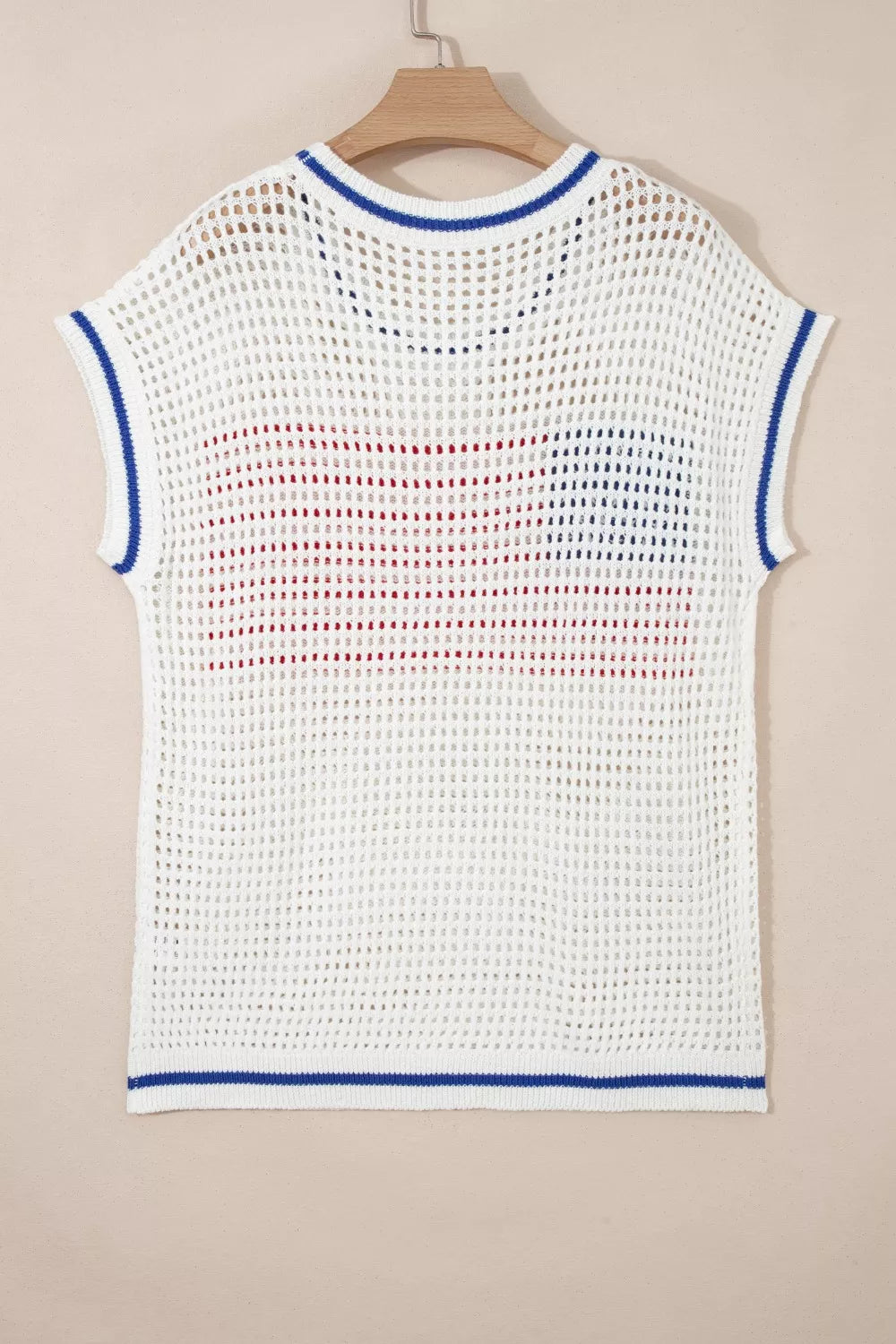 White eyelet knit sweater with cap sleeves, blue trim, and a red and blue American flag pattern.