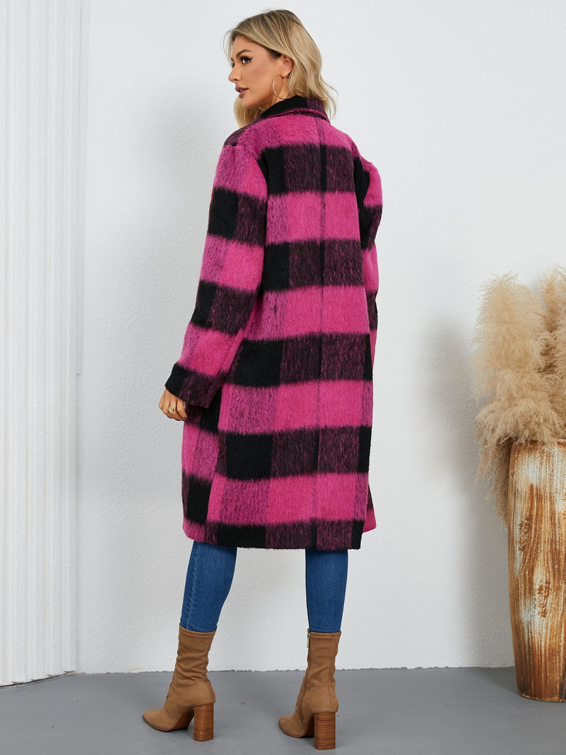 Checked plaid cocoon coat in hot pink and black, with a double-breasted closure.