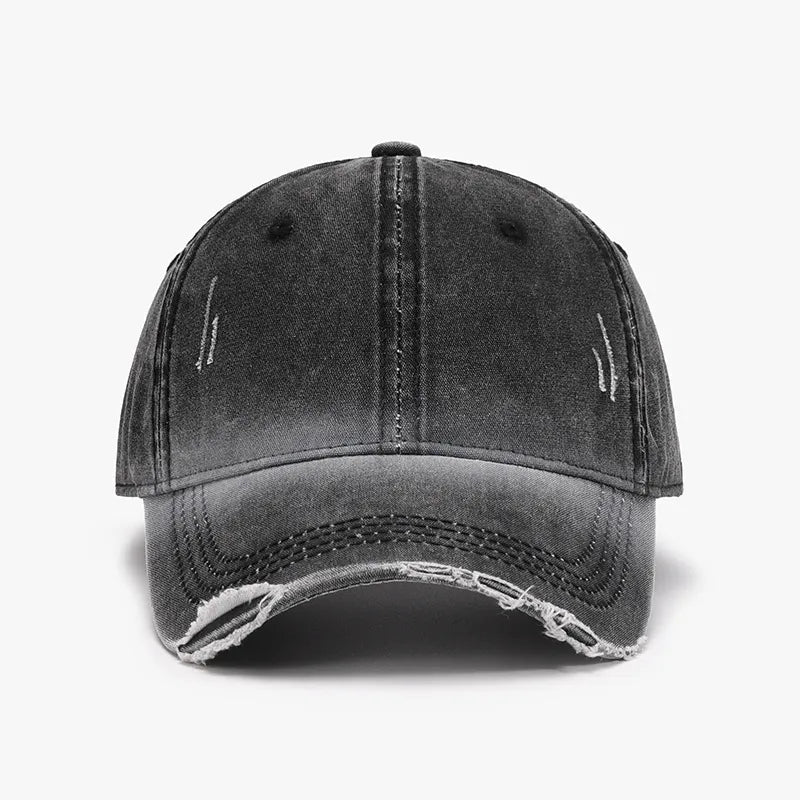 Faded denim baseball cap in dark gray with distressed details and frayed brim.