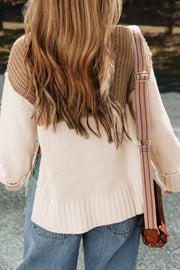 Colorblock ribbed turtleneck sweater in camel and cream acrylic with a side slit detail.