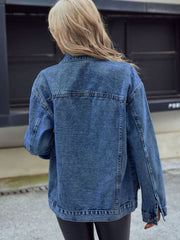 Oversized medium wash denim trucker jacket with classic details and buttoned cuffs.