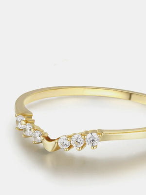 Gold chevron diamond band ring with seven small round stones.