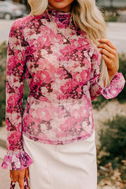 Pink sheer floral long sleeve blouse with ruffle cuffs and mock neck.