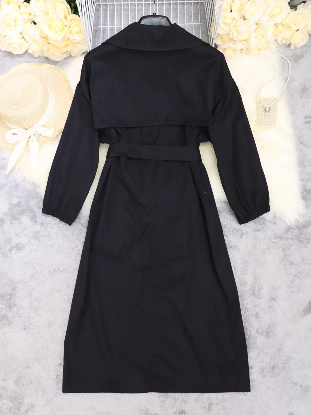 Black midi dress with lapel collar, tie waist, and cuffed sleeves.