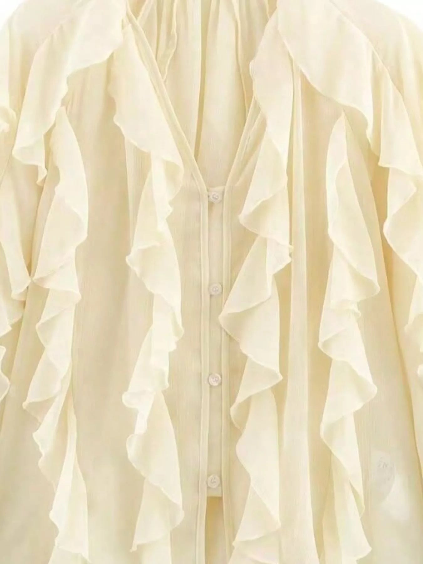 Beige sheer long-sleeve blouse with cascading ruffles and button front.